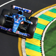 A photo of Fernando Alonso's F1 car rounding a corner in Australia
